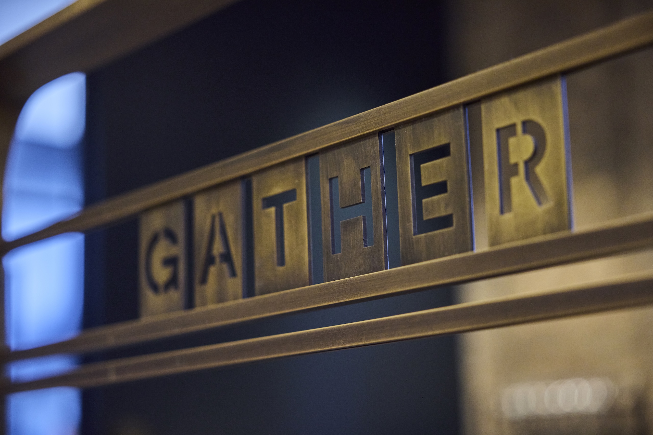 An iron sign that says Gather in all capital letters at Asher Adams Hotel, Salt Lake City